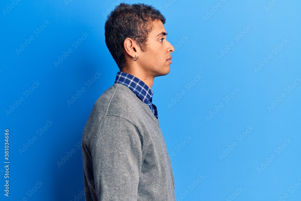 Young african amercian man wearing casual clothes looking to side, relax profile pose with natural face with confident smile. Young african amercian man wearing casual clothes looking to side, relax profile pose with natural face with confident smile.