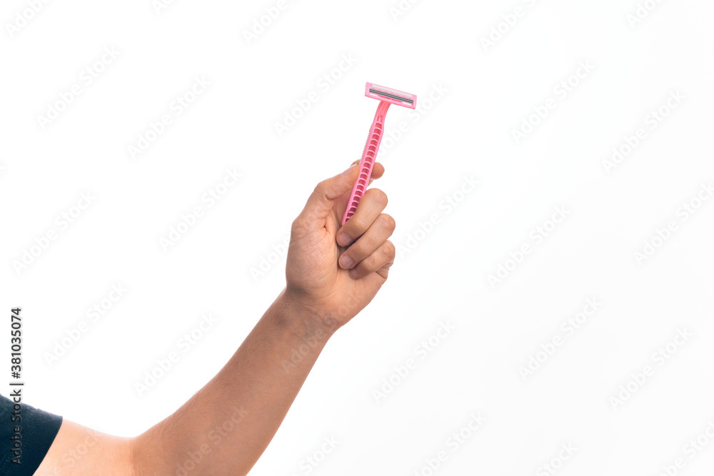 Hand of caucasian young man holding pink disposible razor over isolated white background Hand of caucasian young man holding pink disposible razor over isolated white background