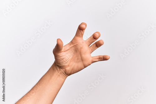 Hand of caucasian young man showing fingers over isolated white background grasping aggressive and scary with fingers, violence and frustration