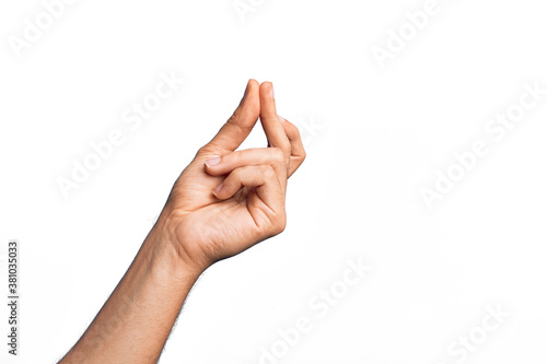Hand of caucasian young man showing fingers over isolated white background snapping fingers for success, easy and click symbol gesture with hand photo