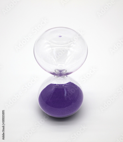 Glass hourglass on white background