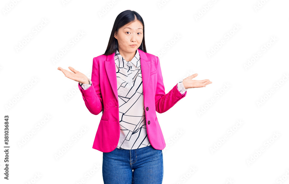Young beautiful chinese woman wearing elegant clothes clueless and confused expression with arms and hands raised. doubt concept. Young beautiful chinese woman wearing elegant clothes clueless and confused expression with arms and hands raised. doubt concept.
