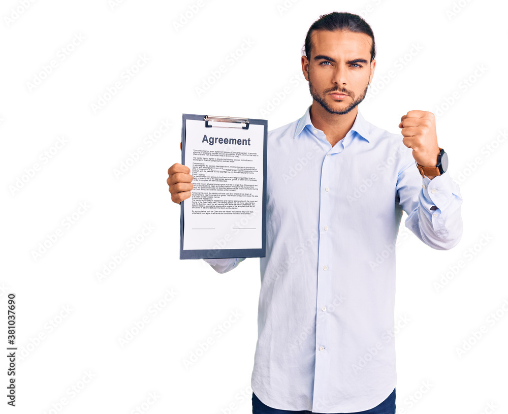 Young handsome man holding clipboard with agreement document annoyed and frustrated shouting with anger, yelling crazy with anger and hand raised Young handsome man holding clipboard with agreement document annoyed and frustrated shouting with anger, yelling crazy with anger and hand raised