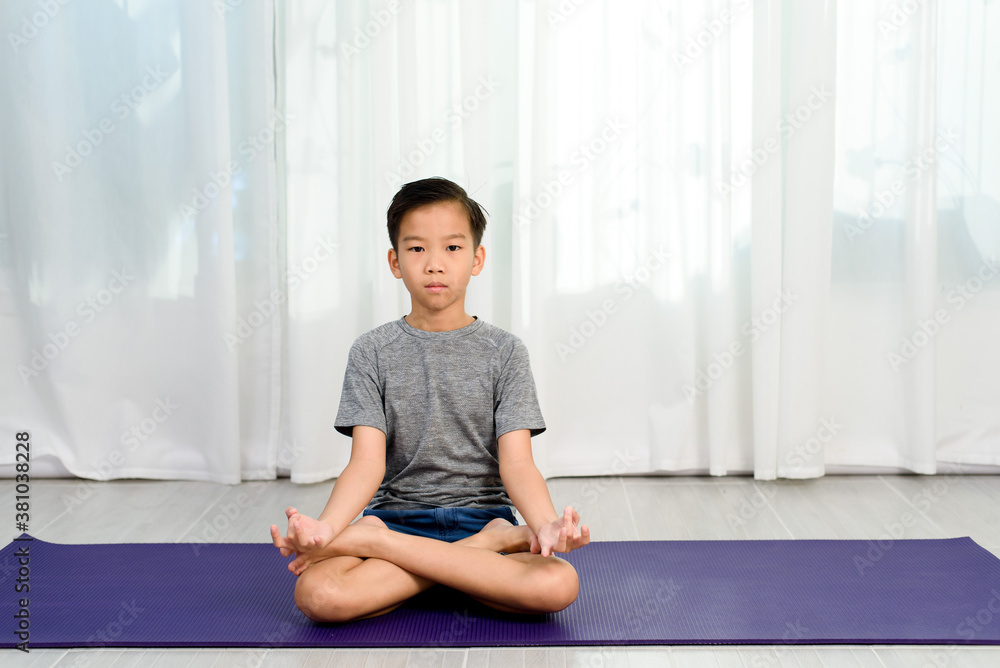 Young boy do yoga in a bedroom Young boy do yoga in a bedroom