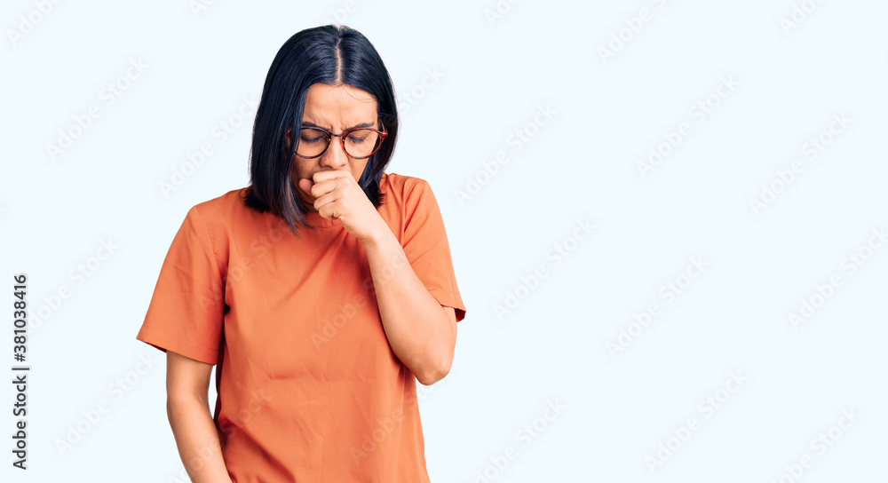 Young beautiful latin woman wearing casual clothes feeling unwell and coughing as symptom for cold or bronchitis. health care concept. Young beautiful latin woman wearing casual clothes feeling unwell and coughing as symptom for cold or bronchitis. health care concept.