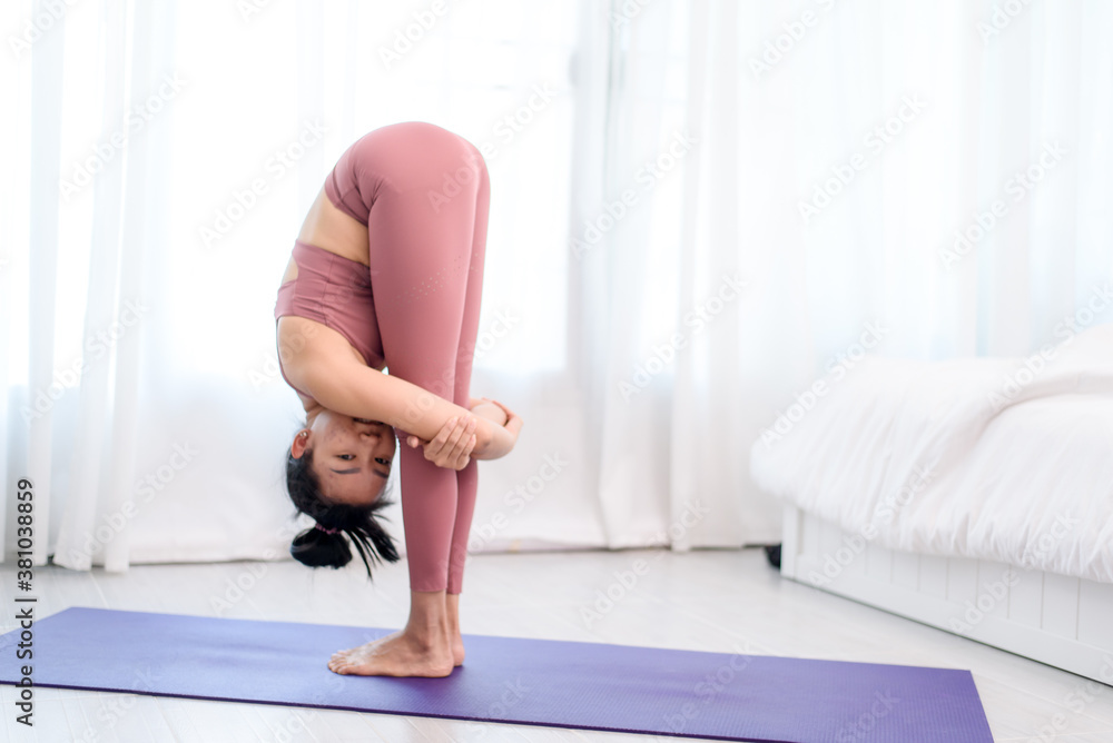 Young woman do yoga in a bed room Young woman do yoga in a bed room