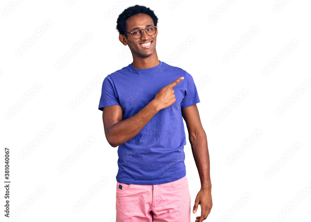 African handsome man wearing casual clothes and glasses cheerful with a smile of face pointing with hand and finger up to the side with happy and natural expression on face African handsome man wearing casual clothes and glasses cheerful with a smile of face pointing with hand and finger up to the side with happy and natural expression on face