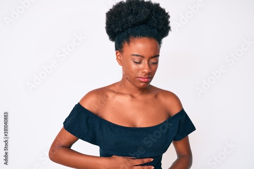 Young african american woman wearing casual clothes with hand on stomach because indigestion, painful illness feeling unwell. ache concept.