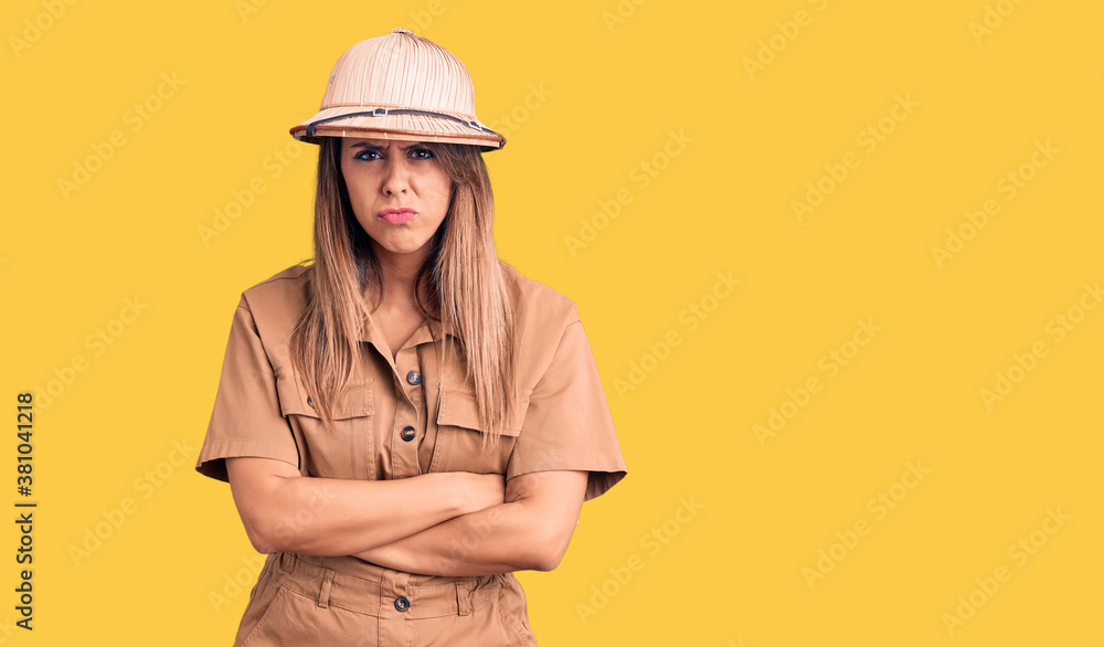 Young beautiful woman wearing explorer hat skeptic and nervous, disapproving expression on face with crossed arms. negative person. Young beautiful woman wearing explorer hat skeptic and nervous, disapproving expression on face with crossed arms. negative person.
