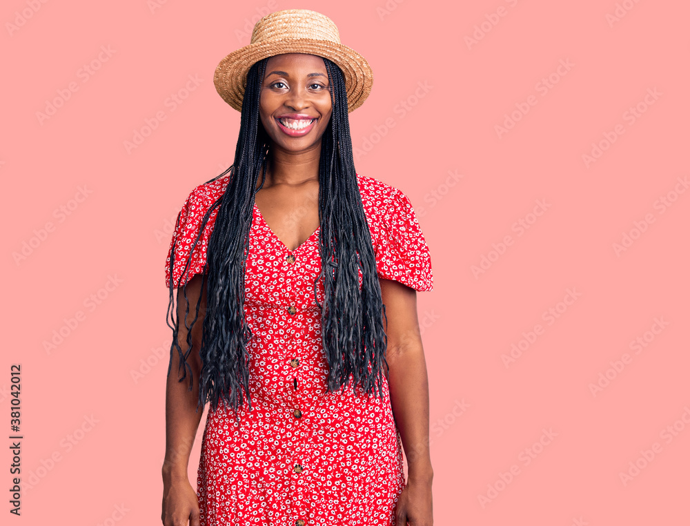 Young african american woman wearing summer hat with a happy and cool smile on face. lucky person. Young african american woman wearing summer hat with a happy and cool smile on face. lucky person.
