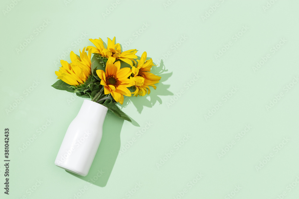 Yellow sunflowers in white vase , view from above. Bright autumn blooming flowers with copy space. Yellow sunflowers in white vase , view from above. Bright autumn blooming flowers with copy space.