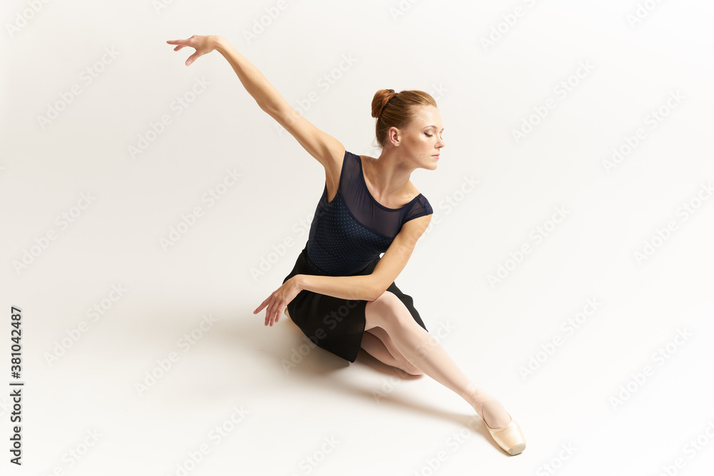 Ballerina in pointe shoes and in a tutu on a light background dance correct positioning of the legs slim figure Ballerina in pointe shoes and in a tutu on a light background dance correct positioning of the legs slim figure