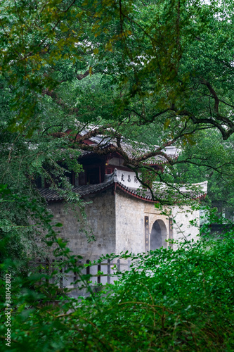 A Chinese historical pavilion under old banyan trees. The text on the building means "cultural prosperity". Located in Yantou village, Lishui, Zhejiang, China.