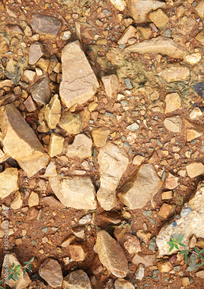 Wet ground, yellow soil, there are many small stones, details of the texture Wet ground, yellow soil, there are many small stones, details of the texture