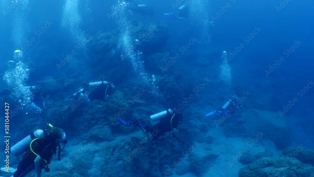 scuba divers exploring the reefs and underwater with rocks ocean scenery enjoying topography mediterranean sea scuba divers exploring the reefs and underwater with rocks ocean scenery enjoying topography mediterranean sea