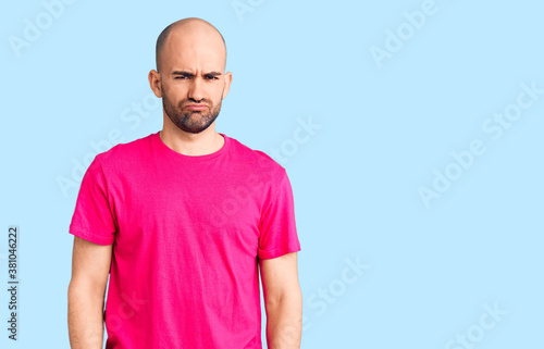 Young handsome man wearing casual t shirt depressed and worry for distress, crying angry and afraid. sad expression.