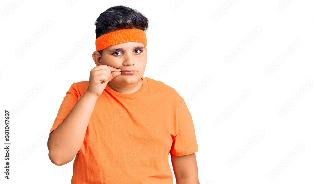 Little boy kid wearing sportswear mouth and lips shut as zip with fingers. secret and silent, taboo talking Little boy kid wearing sportswear mouth and lips shut as zip with fingers. secret and silent, taboo talking