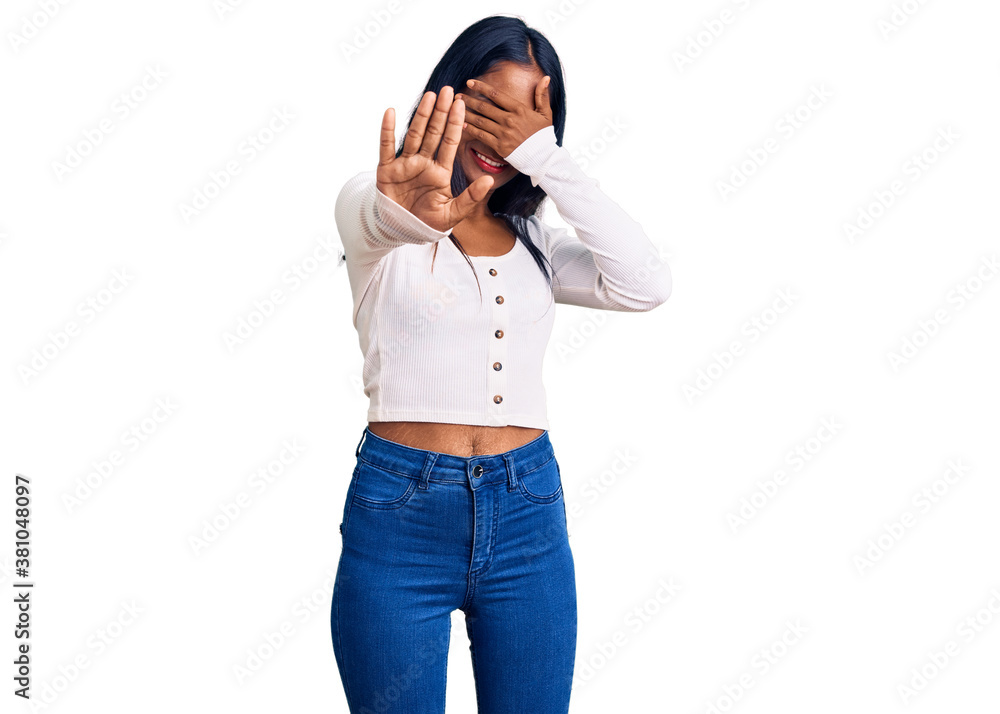 Young indian girl wearing casual clothes covering eyes with hands and doing stop gesture with sad and fear expression. embarrassed and negative concept. Young indian girl wearing casual clothes covering eyes with hands and doing stop gesture with sad and fear expression. embarrassed and negative concept.