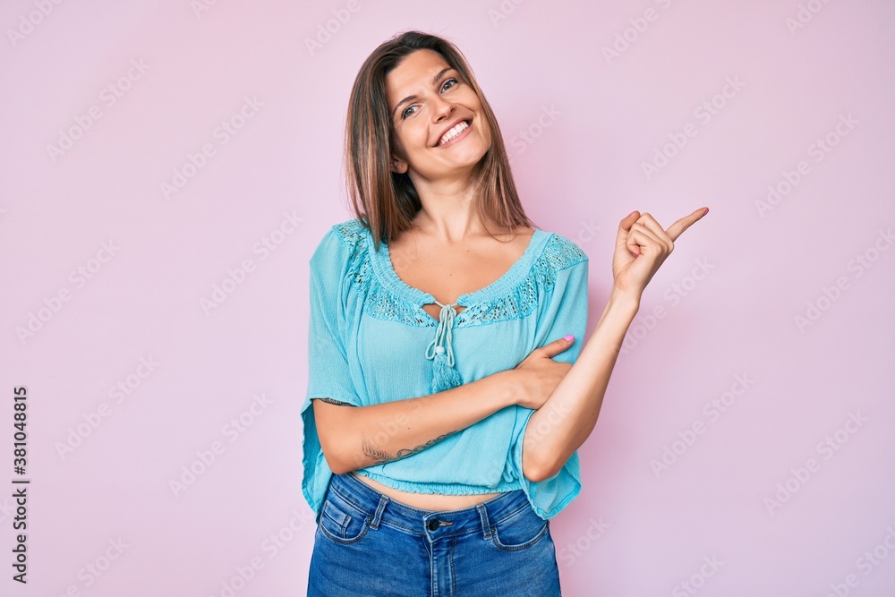Beautiful caucasian woman wearing casual clothes with a big smile on face, pointing with hand and finger to the side looking at the camera. Beautiful caucasian woman wearing casual clothes with a big smile on face, pointing with hand and finger to the side looking at the camera.