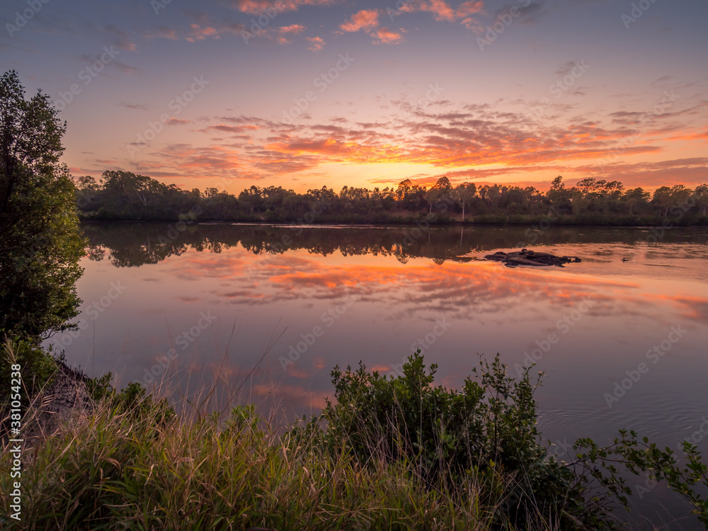 Beautiful Riverside Sunrise with Cloud Reflections