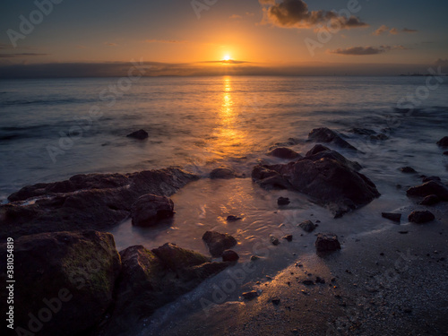 Beautiful Seaside Sunrise with Reflections and Rocks