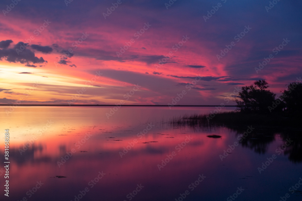 Beautiful sunset at lake Ibera with reflections on the water