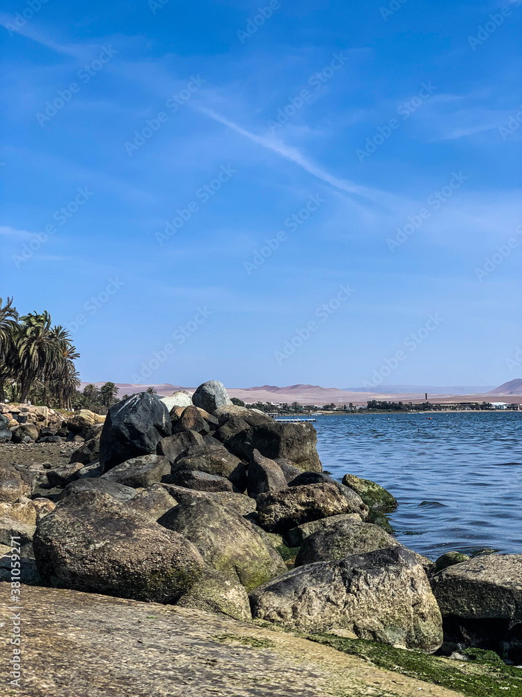 Paracas, bay and natural reserve of Ica in Peru Sea, water, birds, dock, stones. Paracas, bay and natural reserve of Ica in Peru Sea, water, birds, dock, stones.