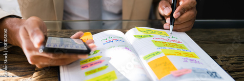 African Man Organizing Appointment Calendar Schedule