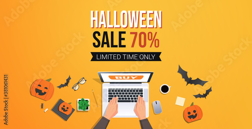 hands using laptop happy halloween sale promotion template seasonal discount greeting card of flyer desk top angle view horizontal vector illustration