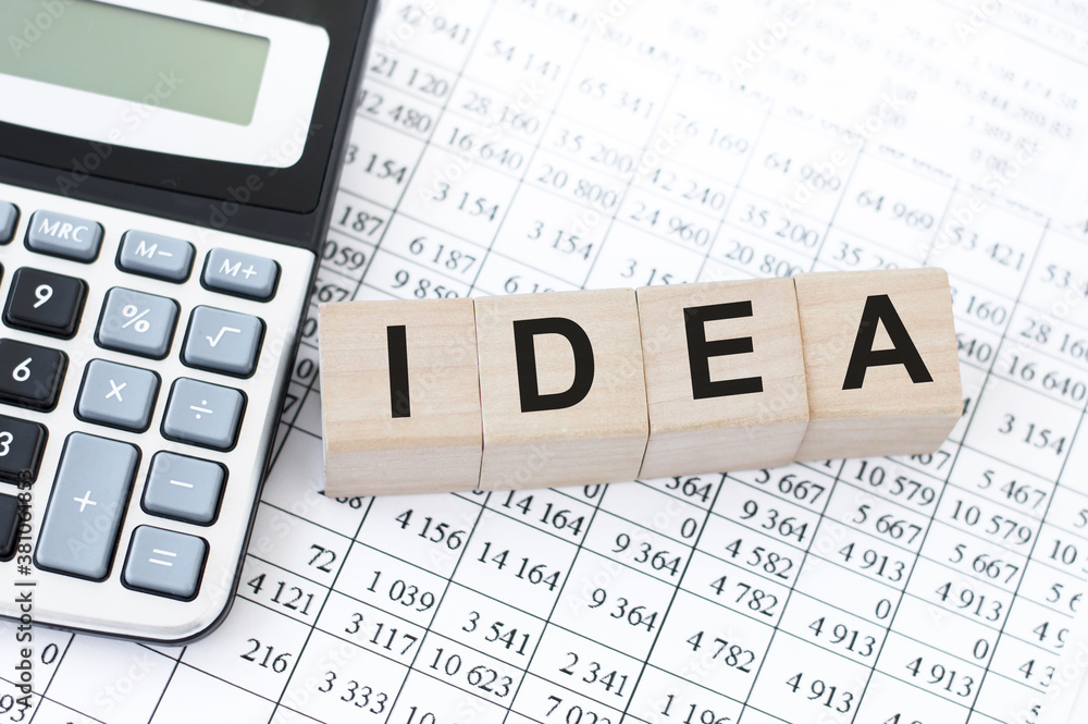 Wooden cubes with letters on the table in the office. Text IDEA. Financial concept. Wooden cubes with letters on the table in the office. Text IDEA. Financial concept.
