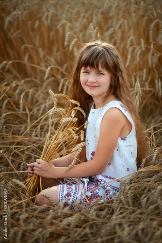 Photo of a Russian girl in a wheat field in summer.