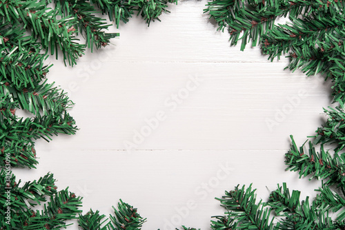 artificial Christmas tree leaf decorate on white wooden background