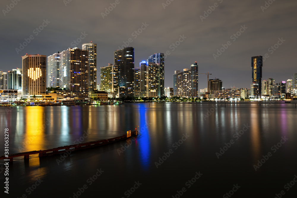 Miami sunset panorama with colorful illuminated business and residential buildings and bridge on Biscayne Bay. Miami skyline on Biscayne Bay, city night backgrounds.