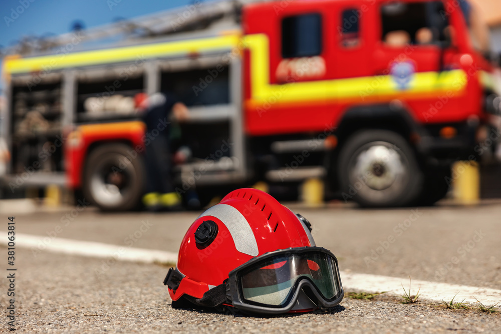 Closeup of protective helmet. In background is fire truck. Closeup of protective helmet. In background is fire truck.