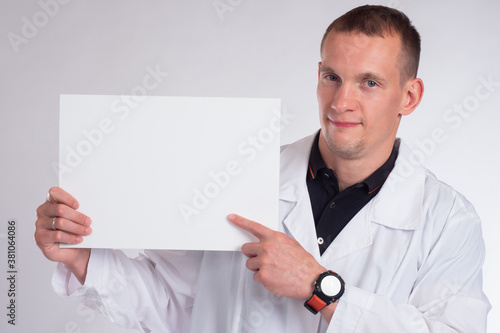 A cheerful doctor holds a s...