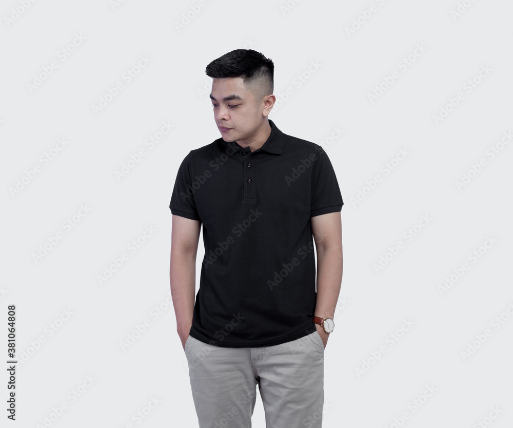 Fototapeta premium Close Up shot of handsome man wearing black polo shirt posing at plain background