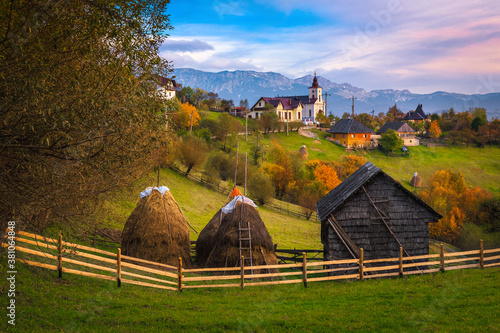 Autumn rural scenery with gardens and mountains in background, Romania