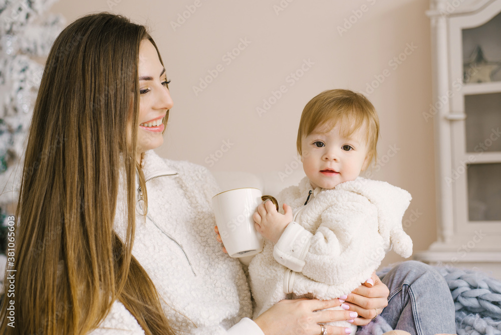 A young mother holds her daughter in her arms. Happy family is a single mom A young mother holds her daughter in her arms. Happy family is a single mom