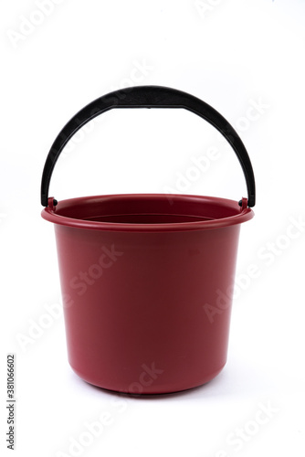 Red bucket made of plastic for various purposes on a white background.