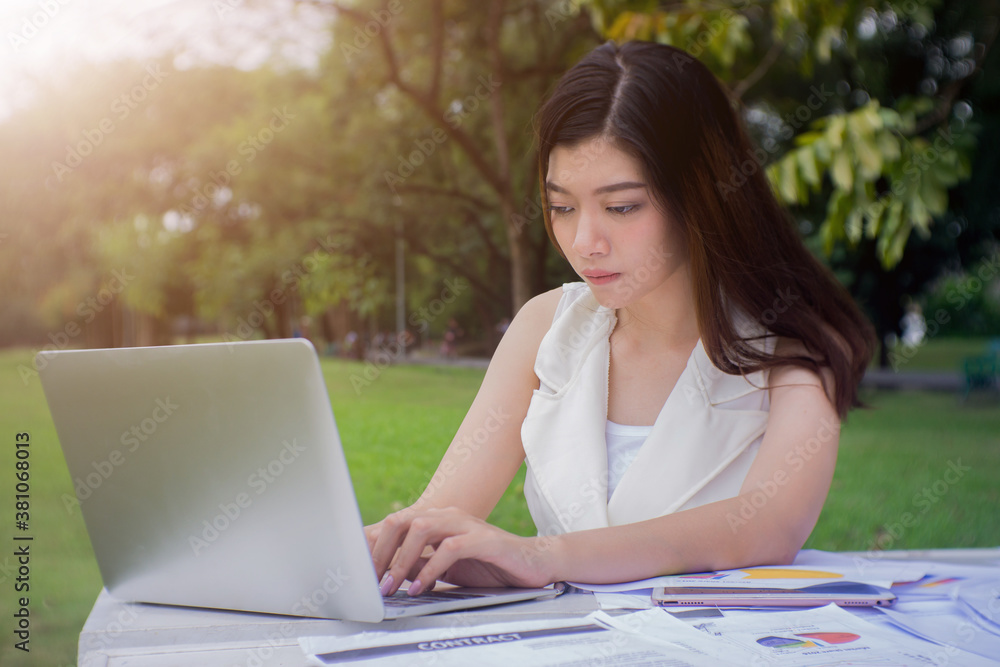 Asian young woman using laptop for online shopping or reading social media. Asian young woman using laptop for online shopping or reading social media.