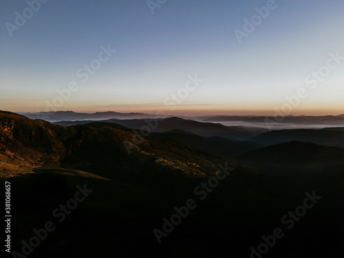 View of the Carpathian Mountains. Green forest against the sky  rocky mountains and beautiful landscape. Autumn in the mountain and forest trees. Mountain view on the sunrise with clouds