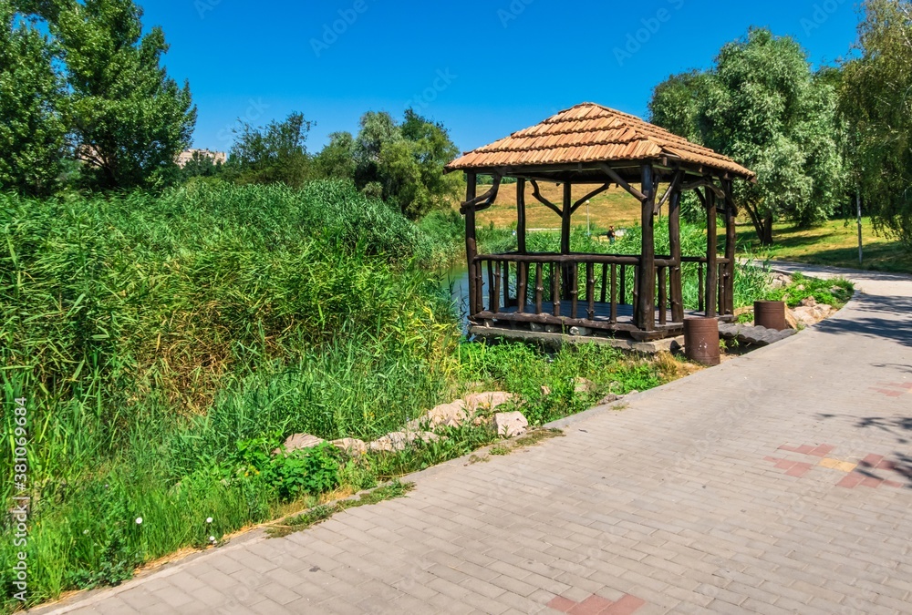 Wooden gazebo by the pond in Zaporozhye, Ukraine