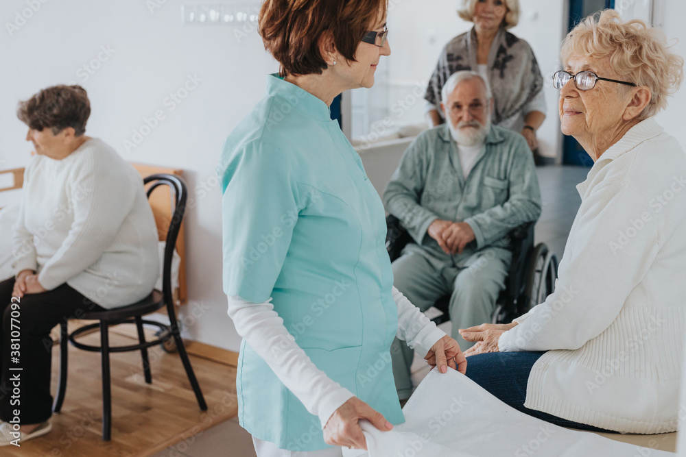 Senior patients and nurse in local nursing home Senior patients and nurse in local nursing home