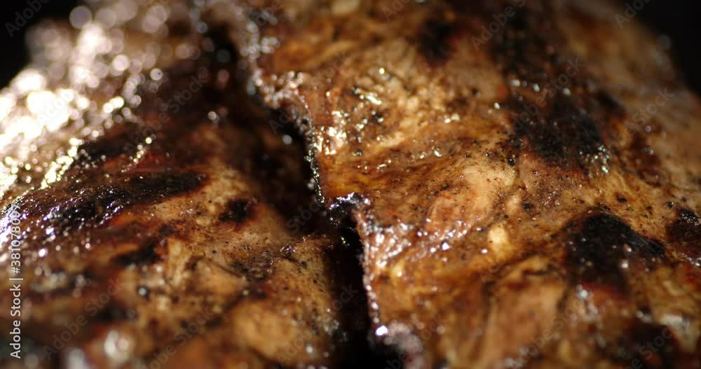 The appetizing ribs on the grill rotate slowly. The appetizing ribs on the grill rotate slowly.