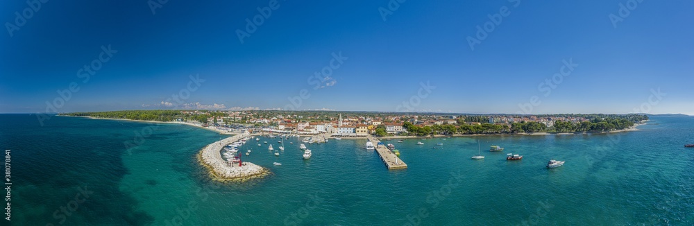 Fototapeta premium Panoramic aerial drone picture over the Istrian town of Fazana with harbour during daytime