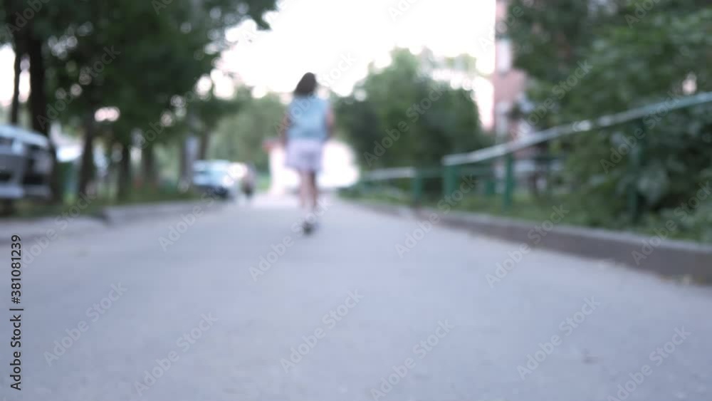 closeup shot of little caucasian girl's legs while she runs on asphalt road. child in skirt and sandals running away outdoors. girl plays at street. children leisure and activity closeup shot of little caucasian girl's legs while she runs on asphalt road. child in skirt and sandals running away outdoors. girl plays at street. children leisure and activity