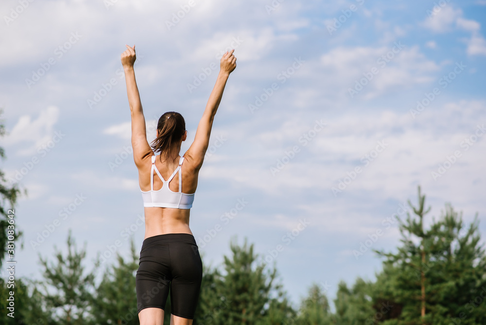 Young slim fit woman doing sport exercise outdoors in the park at the sunny day Young slim fit woman doing sport exercise outdoors in the park at the sunny day