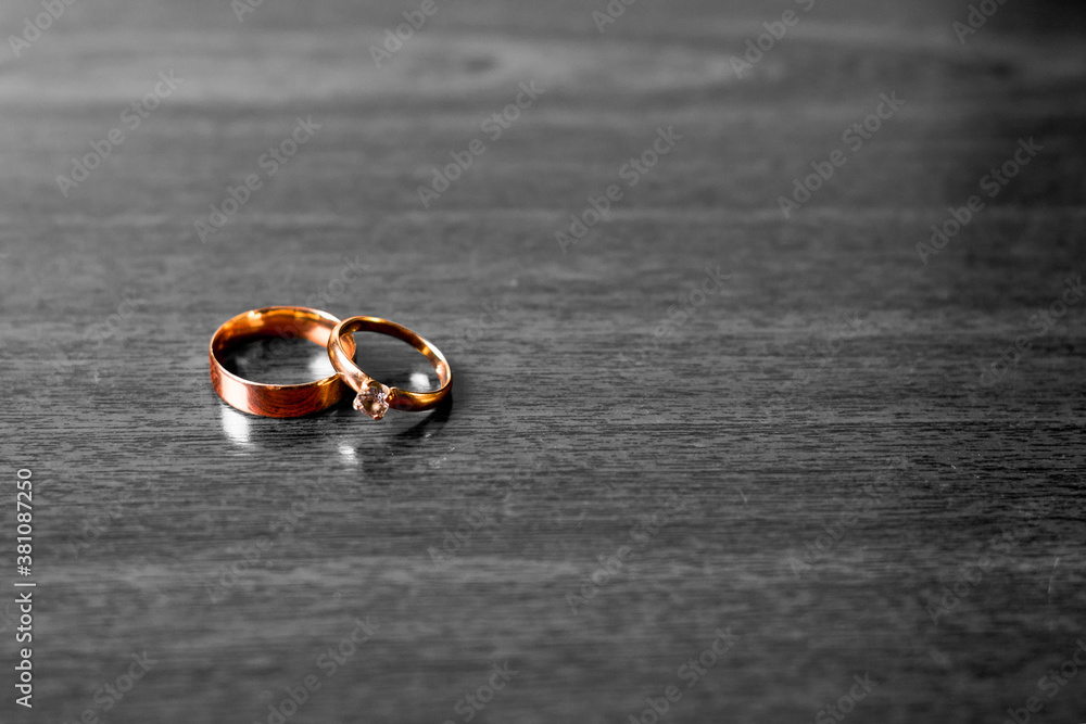 Gold wedding rings on a black white background.Wedding attributes. Wedding ceremony Gold wedding rings on a black white background.Wedding attributes. Wedding ceremony