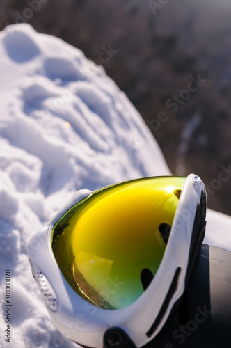 Ski goggles and helmet in the snow