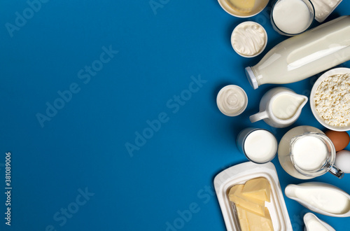 Collection of dairy products on blue background, top view